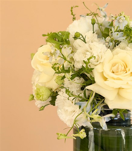 Arrangement of White Roses and Lisianthus in a Veil Glass Vase