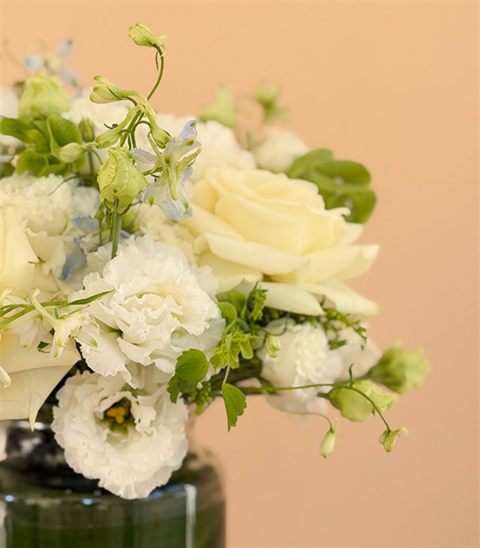 Arrangement of White Roses and Lisianthus in a Veil Glass Vase