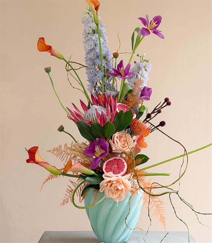 Vittoria Turquoise Vase with Protea and Tulip Exotic Flower Arrangement