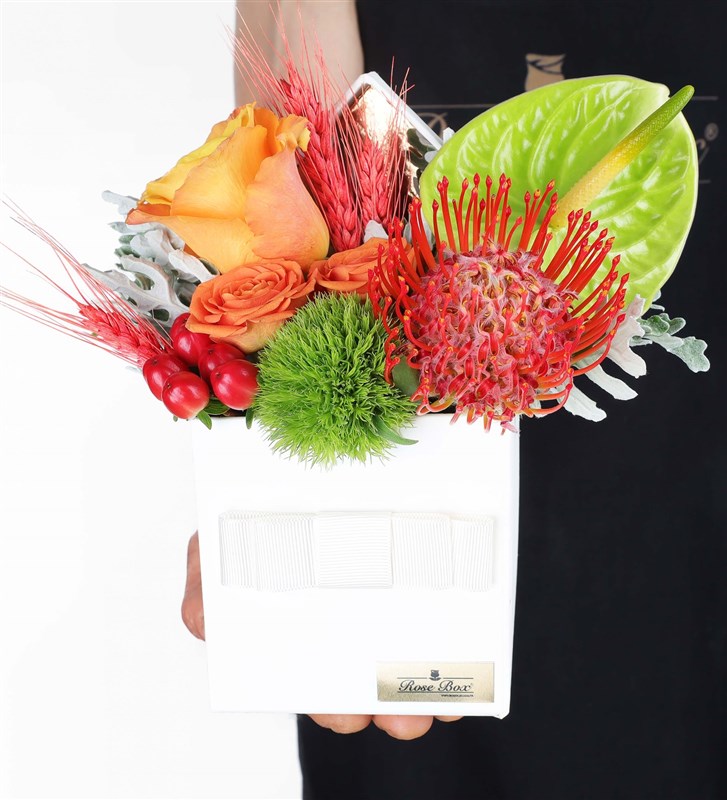 Arrangement of Lecuspermu Orange Roses and Anthuriums in a White Box