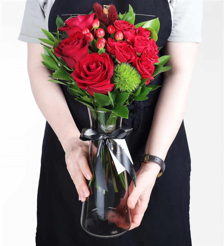 Arrangement of Red Arbor and Ecuadorian Roses in a Black Glass Vase