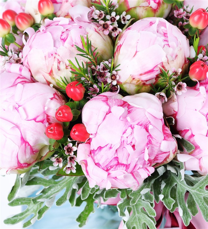 Hypericum and Peony Arrangement in a Blue Glass Vase