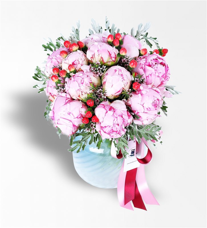 Hypericum and Peony Arrangement in a Blue Glass Vase