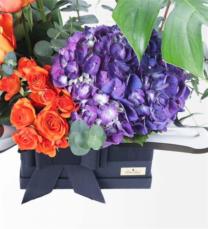Flower Arrangement in a Black Box with Purple Hydrangeas and Orange Roses (XL)